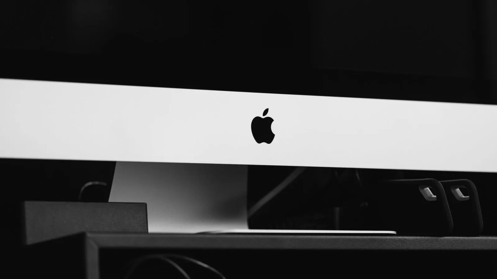Sleek black and white minimalist desktop setup featuring modern technology in an indoor setting.