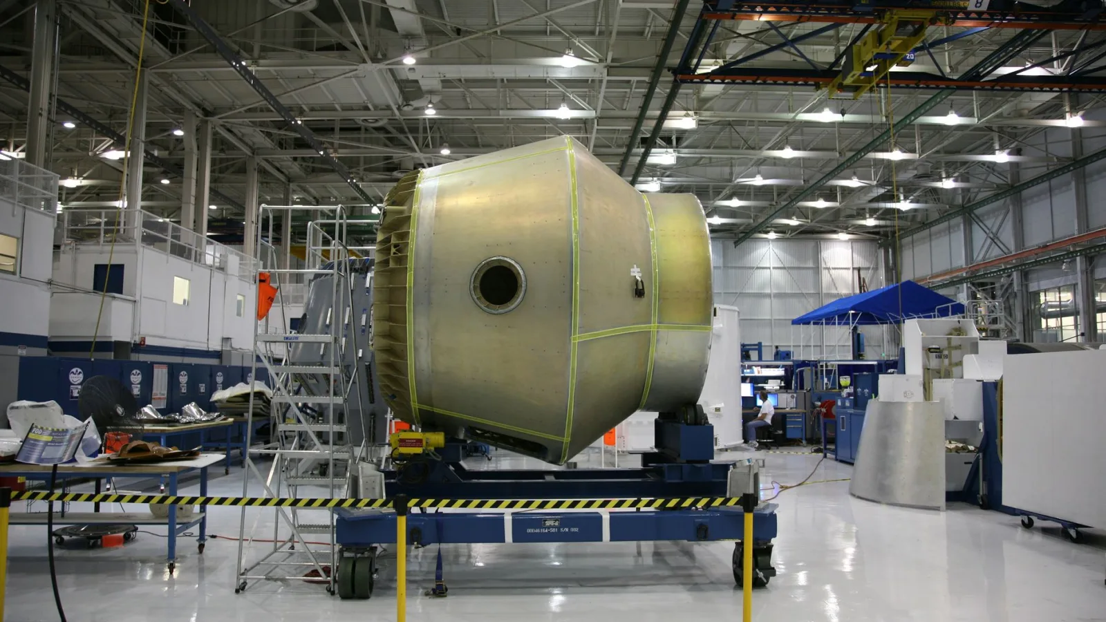 Heavy detail of spacecraft placed on rolling platform under construction at futuristic rocket factory