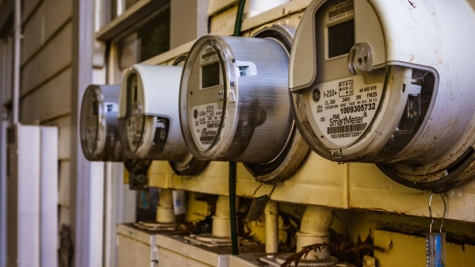 Image of multiple smart electricity meters installed on a residential exterior wall, showing environmental adaptation.