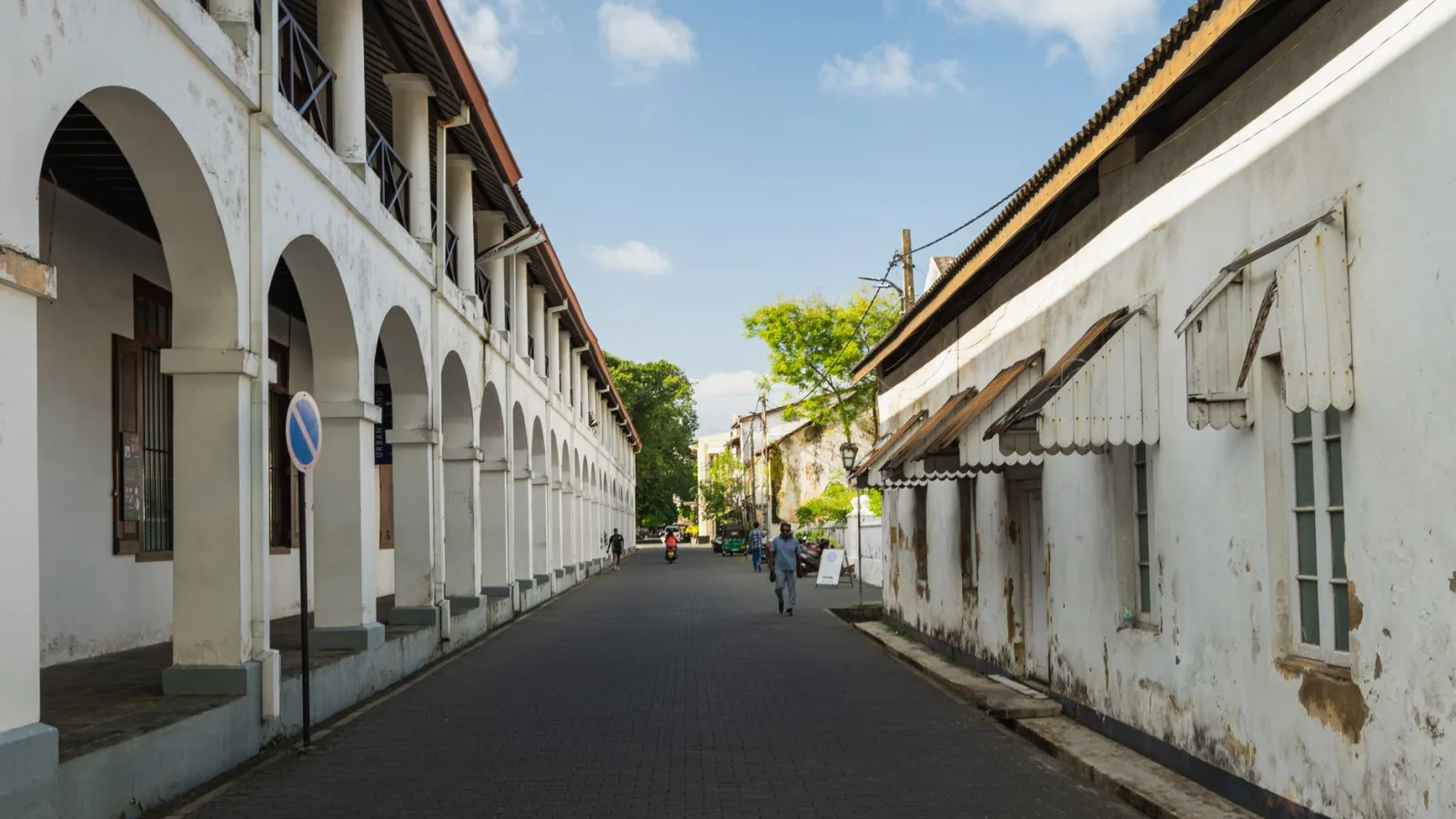 Charming view of a historic street in Galle Fort, Sri Lanka, showcasing colonial architecture and a serene urban environment.